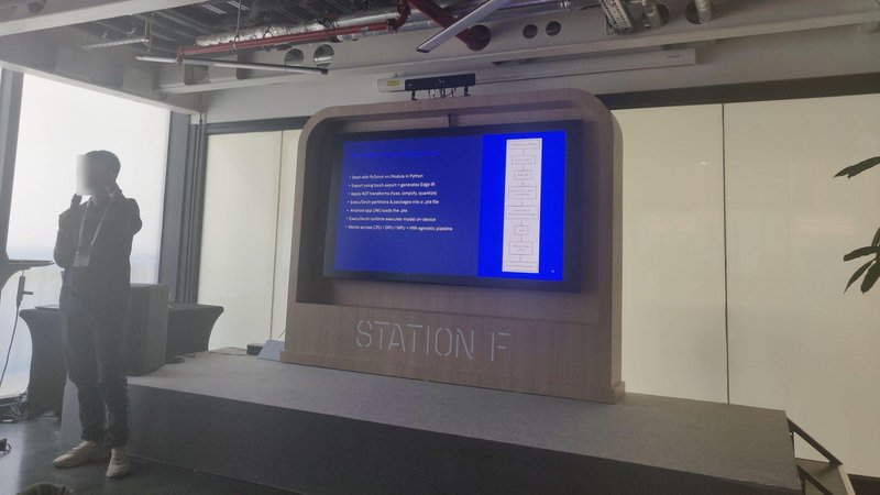 Qualcomm presenter walking through on-device LLM inference on Android with ExecuTorch in an upper-floor room at Station F